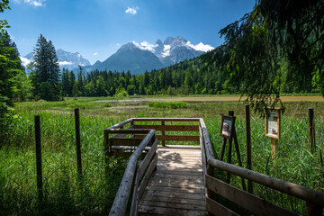 View from a viewing platform over the idyllic Taubensee towards the Hochkalter mountain range, Ramsau in summer, Bavaria, Germany