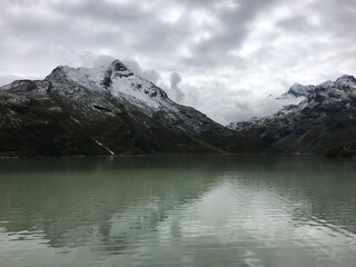 Panorama of alpine mountains covered with snow and a lake in Austria