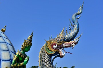 Fototapeta na wymiar Naga Sculpture with Blue sky at Wat Rong Sua Ten (Blue temple), Chiangrai Thailand.