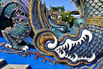 Fototapeta premium Thai sculpture on the stair Wat Rong Sua Ten (Blue temple), Chiangrai Thailand.