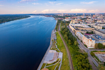Fototapeta premium Aerial top view panorama city Perm and central embankment of Kama river Russia, sunset drone photo