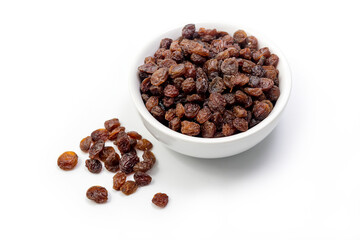 Brown raisins in white bowl isolated on white background