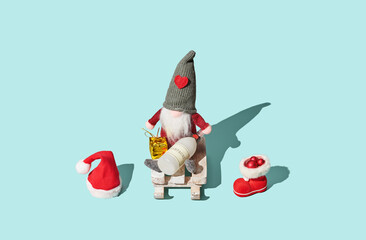 Santa Claus with champagne bottle on blue pastel background