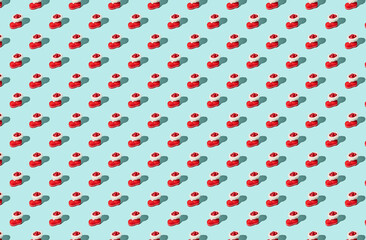 Pattern of red Santa's boot on green pastel background