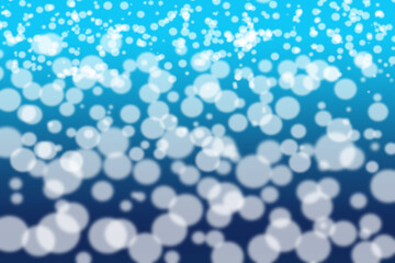 Abstract background - white bokeh on a blue background.