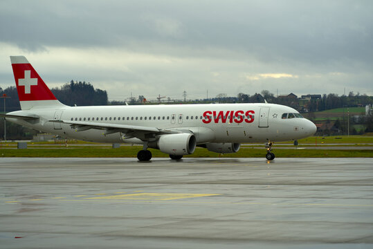 Swiss airplane Airbus A320 register HB-IJI taxiing to runway at Z¨ürich Airport on a rainy winter day. Photo taken December 26th, 2021, Zurich, Switzerland.