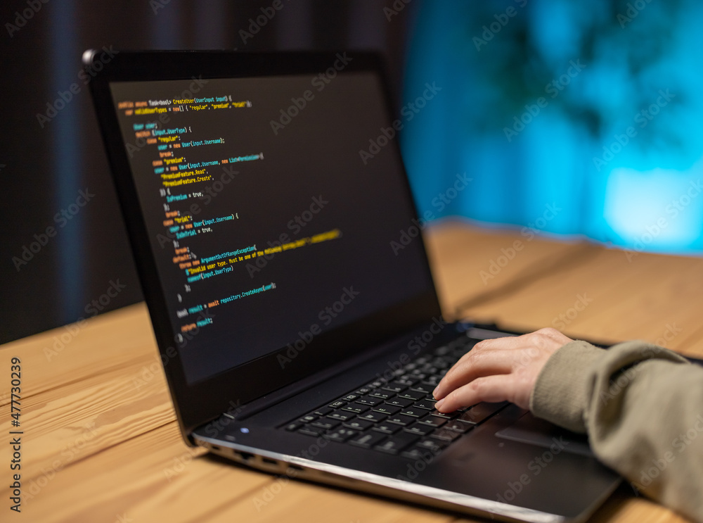 Poster close up of female hands typing on modern laptop while writing data code. woman in eyeglasses sittin