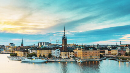 Fototapeta na wymiar Stockholm, Sweden. Scenic View Of Stockholm Skyline At Summer Evening. Famous Popular Destination Scenic Place In Dusk Lights. Riddarholm Church In Day To Night Transition