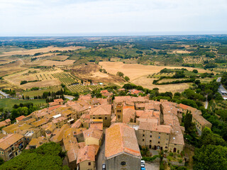 Fototapeta na wymiar Casale Marittimo, Tuscany, Pisa region, Medieval old town with cypress tress and crops hay, city on a hill top, landscape drone aerial panorama 
