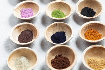 Set of natural pigment powder from herbs in small bowls. Dye from nature.