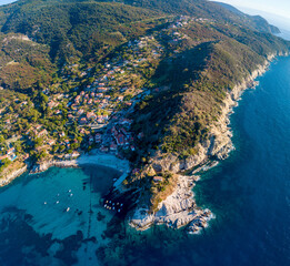 Aerial drone panorama view of the coast line, beach and crystal clear water of elba close to Sant'Andrea, Italy - obrazy, fototapety, plakaty