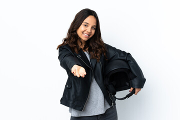 Young woman holding a motorcycle helmet over isolated white background holding copyspace imaginary...