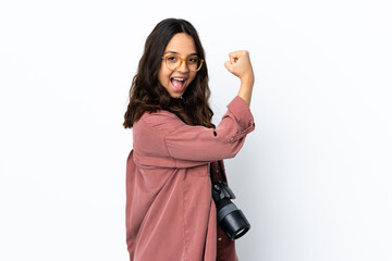 Young photographer woman over isolated white background doing strong gesture