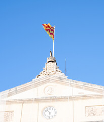 Flag of Tarragona flying on the main flagpole of the city hall