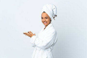 Young woman in bathrobe over isolated white background applauding