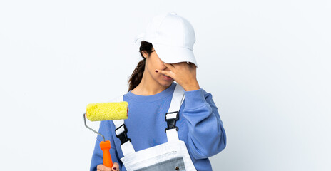 Painter woman over isolated white background with headache
