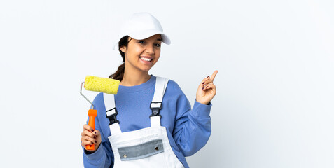 Painter woman over isolated white background happy and pointing up