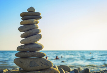 beach pebble tumbled stones pyramid on sea shore