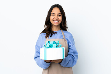 Pastry chef holding a big cake over isolated white background focusing face. Framing symbol