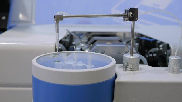 Atomic absorption spectrometer for analyzing concentration of elements in liquid sample at pharma exhibition. Pharmaceutical, chemistry and laboratory equipment concept