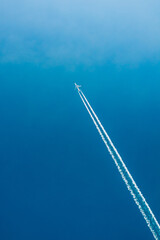 Airplane In Sky With Plane Trails