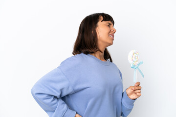 Young mixed race woman holding a lollipop isolated on white background suffering from backache for having made an effort