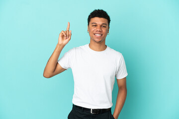 Young African American man isolated on blue background pointing up a great idea