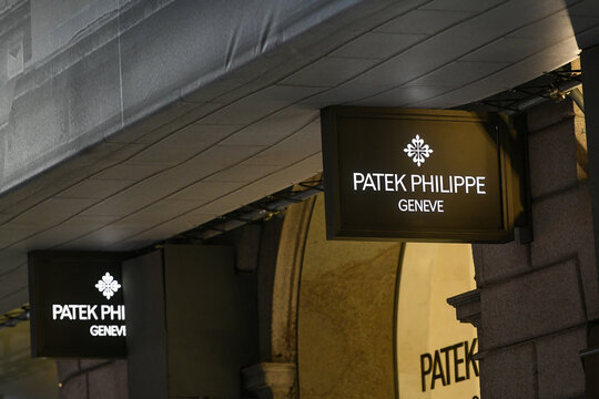 Patek Philippe logo displayed on a facade of a store in Milan.