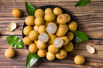 fresh longans in plate on wooden table