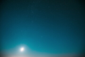 Fototapeta na wymiar 6K 5K Blue Scenery Background Moonrise Night Starry Sky Glowing Stars. Scenic Bright Glow Of Sky Stars Galaxy 4K. Natural Background Backdrop