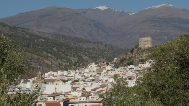Velez de Benaudalla village with Sierra Nevada at background a sunny day