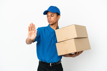 Delivery African American man isolated on white background making stop gesture and disappointed