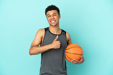 Obraz premium Basketball player African American man isolated on blue background giving a thumbs up gesture