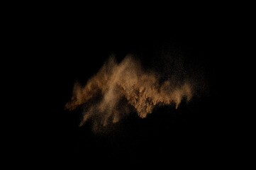 Sandy explosion isolated on black background. Abstract sand cloud.