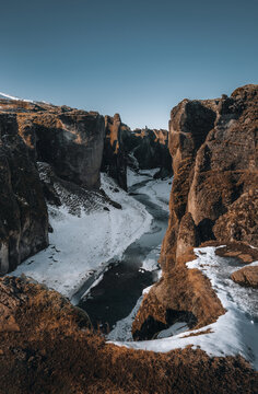 Aerial Drone view of Fjadrargljufur canyon and Fjadra river at winter. White snow and blue river. Iceland near Reykjavik.