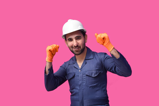 construction worker smiling and wearing blue shirt with safety halmet indian pakistani model