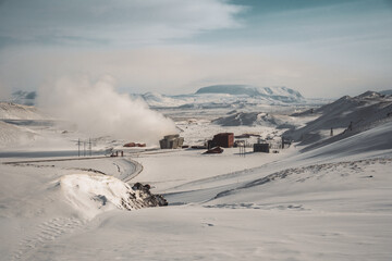 Icelandic landscape with geothermal power plant station kravla with igloo huts and pipes in the...