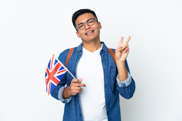 Young Ecuadorian woman holding an United Kingdom flag isolated on white background smiling and showing victory sign