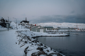 Town of Holmavik in Steingrimsfjordur fjord in Strandir in North Iceland during winter with snow.