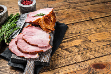 Cold Smoked pork sirloin meat with herbs on rustic board. Wooden background. Top view. Copy space