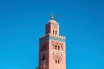 Obraz premium Koutoubia Mosque with traditional islamic ornament and decoration at minaret tower against clear blue sky