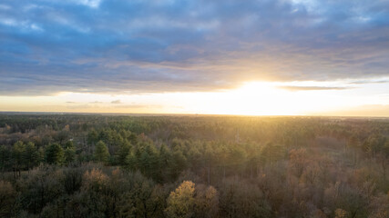 Beautiful sunset over a river with green bushes and color rich sky. High quality photo