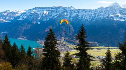 Paragliding over Swiss lake and mountains in Interlaken