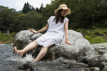 Girl on a rock in the river