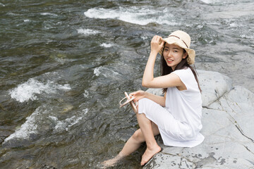 Girl on a rock in the river