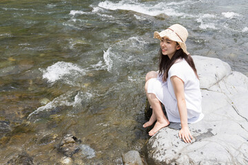Girl on a rock in the river