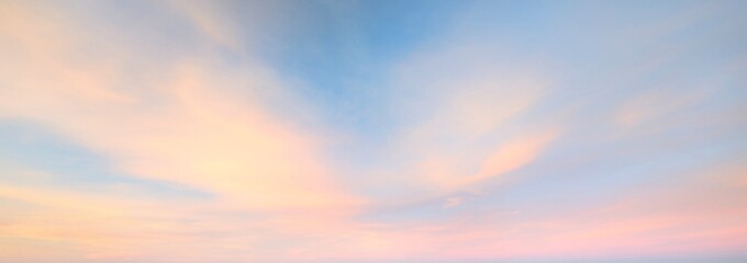 Clear blue sky with glowing pink and golden clouds after the storm. Dramatic sunset cloudscape....
