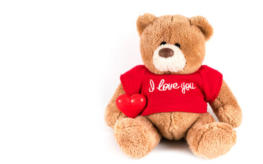 Teddy bear with heart on white background.