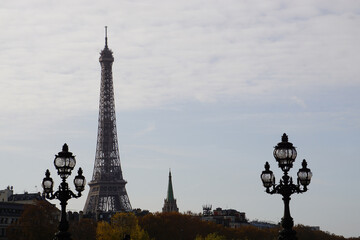 Fototapeta na wymiar top of eiffel tower, church and old fashion street lights in paris france in autumn 