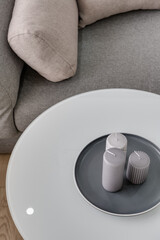 coffee table with candles on the background of a gray sofa